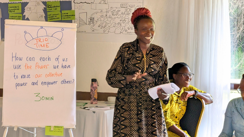 Mastercard Foundation Scholar Ruth Singen presenting in front of a whiteboard