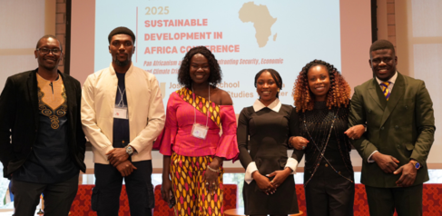 Mastercard Foundation Scholar Favour Peters with conference team on stage