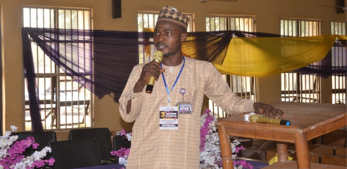 Mastercard Foundation Scholar Abraham Zhiri speaking at a conference