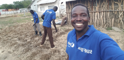 Mastercard Foundation Scholar Lagu Emmanuel Anthony planting vegetable seeds in Akobo West, South Sudan