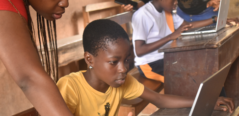 A student looking intently at a laptop screen during class