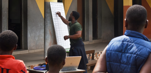 Volunteer leading a quiz at a digital literacy class in Lagos